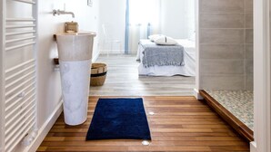 A modern bathroom with a large mirror, a white sink, and a shower area. - La Palangre by Interhome (Argelès sur Mer)