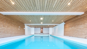 A modern indoor swimming pool with wooden panel walls and a clean, bright interior. - Hameau D01 by Interhome (Thyon-Les Collons)