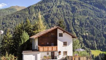 Situated in a mountainous area, this chalet offers a balcony with seating area and a well-manicured lawn.