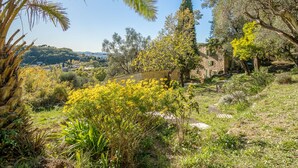 A stone building surrounded by lush greenery and trees. - Le Clermont by Interhome (Chateauneuf de Grasse)
