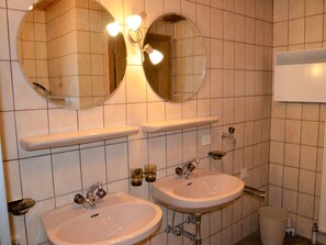 A bathroom with two sinks, a mirror, and a towel rack. - Hedwig Jäger by Interhome (Kappl)