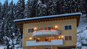 A multi-story building with balconies, surrounded by snow-covered trees. - Apart Garni Wachter by Interhome (Kappl)