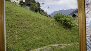 A view of a hillside with buildings, a cable car, and mountains in the background. - Apartment Silvia by Interhome (Kappl)