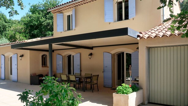 A two-story house with a covered patio, outdoor seating, and a garage. - Sweet Home in Luberon by Interhome (Villelaure)