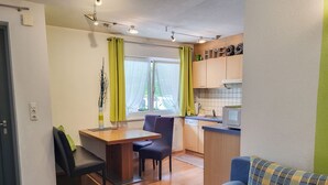 A compact living space with a kitchenette, a dining area, and a seating area. - Michael by Interhome (Kappl)