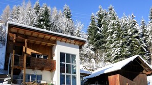 A modern two-story building named "Haus Michael" with a wooden balcony and large windows. - Michael by Interhome (Kappl)