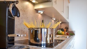 A kitchen with a pasta cooker, a pot of spaghetti, and a stove. - Wechner by Interhome (Kappl)