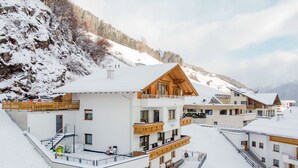 A snow-covered mountain village with chalet-style buildings featuring balconies and wooden facades. - Wechner by Interhome (Kappl)