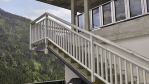 A staircase leading to a balcony with a view of a forested mountain. - Apartment Selina by Interhome (Kappl)