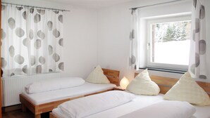 A room with two wooden beds, white bedding, and a window with curtains. - Altes Zollhaus by Interhome (Nauders)