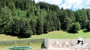 A patio area with outdoor furniture, a barbecue grill, and a trampoline. - Altes Zollhaus by Interhome (Nauders)