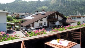 A chalet with a sloped roof, a balcony with wooden railings, and a view of a mountainous landscape. - Apart Grazia by Interhome (Prutz/Kaunertal)