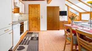 A compact kitchen with wooden cabinets and a built-in stove. - Rosi Studio by Interhome (Sölden)