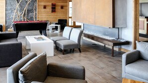 A modern living room with a pool table, sofas, and a fireplace. - Le Roc Belle Face by Interhome (Bourg St Maurice)