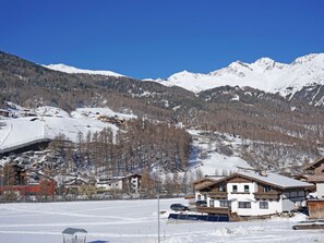 Escape to a mountain retreat with breathtaking views of snow-covered peaks and ski slopes.