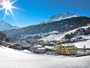 Surrounded by snow-covered mountains, this charming town offers breathtaking views of a prominent peak.