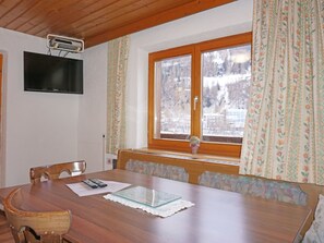 Enjoy meals in this dining area with a flat-screen TV and a view of the surrounding landscape.