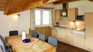 A cozy kitchen with wooden cabinets, a microwave, and a sink.