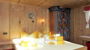A wooden room with a bed, a wardrobe, and a small table. - Hannelore by Interhome (Sölden)
