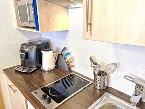 Fridge, microwave, cookware/dishes/utensils, dining tables