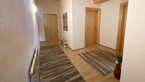 A hallway with wooden beams, a bench, and two doors. - Lili - Top 1 by Interhome (Längenfeld)
