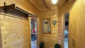 A wooden interior with a bench, a heart-shaped decoration, and a mirror on the wall. - Jochblick by Interhome (Wildschönau)