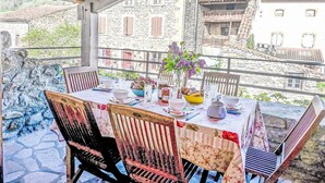 A table set for two with a view of stone buildings in the background.