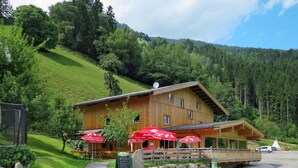 A wooden chalet with outdoor seating and a stone pathway leading to the entrance. - Talbach by Interhome (Mayrhofen)