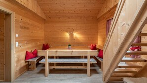 A wooden interior with a dining table, benches, and a staircase. - Talbach by Interhome (Mayrhofen)