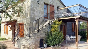 A stone building with a staircase leading to a balcony. - Madaillan by Interhome (Prayssas)