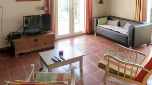 A living room with a television, sofa, and two chairs. - Roque Piquet by Interhome (L'Honor-de-Cos)