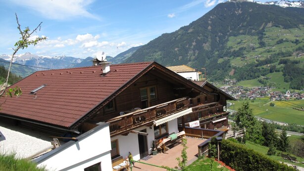 A traditional chalet with a sloped roof, wooden balcony, and a view of a valley and mountains in the background. - Unterkreuter by Interhome (Kaltenbach)