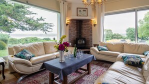 A cozy living room with two sofas, a coffee table, and a fireplace. - Ker Svea by Interhome (Plestin les Greves)