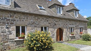 A stone building with a sloped roof, multiple windows, and a central entrance. - Pors Ar Goff by Interhome (Plestin les Greves)