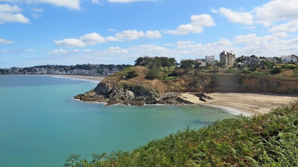 A coastal town with a prominent building on a hill overlooking the sea. - Valhalla, chez Jules by Interhome (Planguenoual)