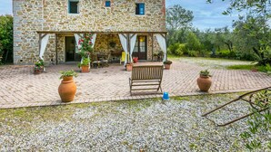 A stone building with a patio area, outdoor seating, and potted plants. - La Casina by Interhome (Vinci)
