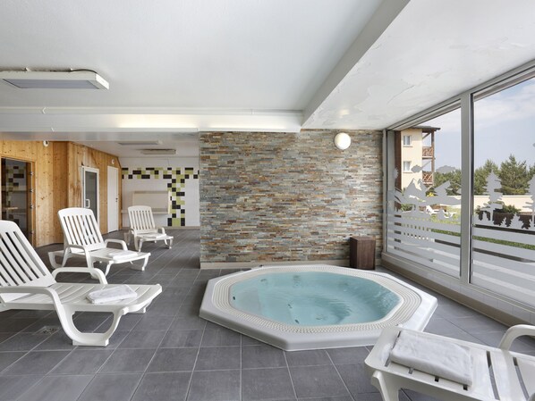 Relax by the pool surrounded by a clear view of the surrounding landscape and comfortable lounge chairs.