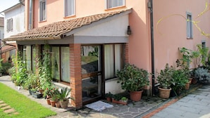 A two-story house with a tiled roof, large windows, and a brick entrance. - Agrifoglio by Interhome (Lucca)