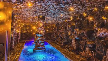 Experience the serenity of a tranquil water feature, surrounded by unique stone walls.