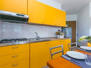 Fridge, cookware/dishes/utensils, dining tables