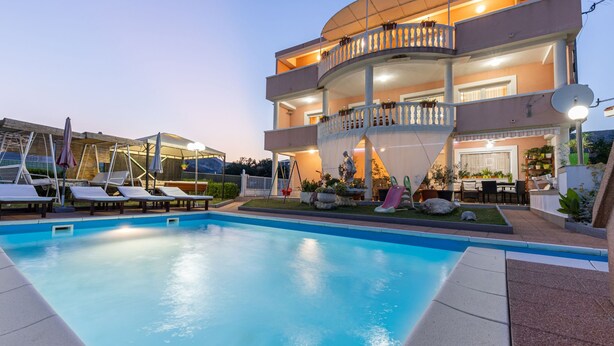 A two-story building with a swimming pool, outdoor seating, and a covered area with plants. - Villa Saba by Interhome (Trogir)
