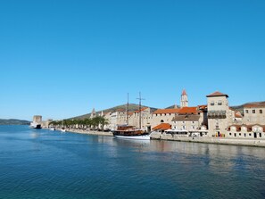 A coastal town with historic buildings, a marina, and a prominent church tower. - Ria with heated pool by Interhome (Trogir)