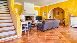 A spacious living area with a fireplace, a sofa, and a television. - Vacation home Solena by Interhome (Flayosc)