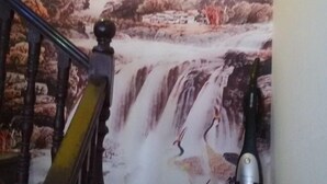 A staircase with a waterfall mural on the wall behind it. - 365 Boutique Inn (Kunshan)