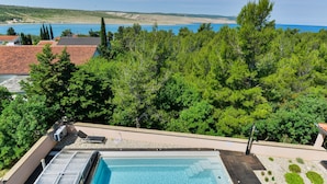 Une piscine avec vue sur une plage et une forêt.