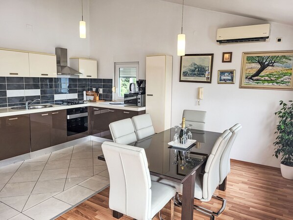A modern kitchen with a dining area. - Mirjana by Interhome (Starigrad-Paklenica)