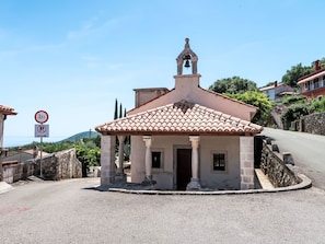 A small building with a bell tower, a no parking sign, and a view of the sea. - Apartment Branka by Interhome (Mošćenička Draga)