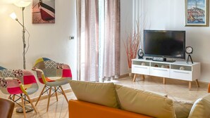 A living room with a sofa, chairs, a TV, and a white cabinet. - Apartment Čančar by Interhome (Poreč)