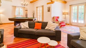 A cozy living room with a pool table, a sofa, a chair, and a small table. - Micocoulier by Interhome (Bagnols en Forêt)