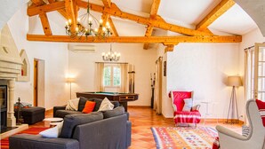 A spacious living room with a pool table, a fireplace, and a cozy seating area. - Micocoulier by Interhome (Bagnols en Forêt)